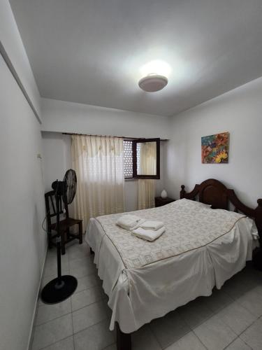 1 dormitorio con 1 cama con 2 toallas en Departamento Atlántico I en San Bernardo