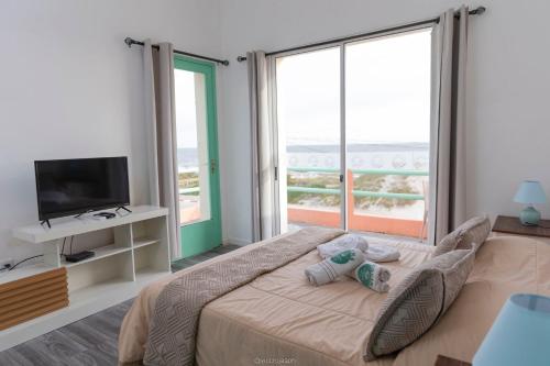 a bedroom with a large bed and a television at Hotel Vista La Floresta in La Floresta