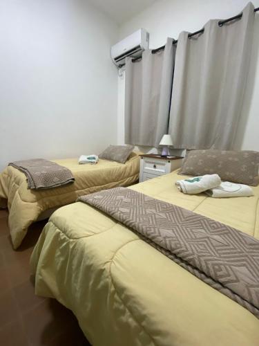 a room with two beds and a window with curtains at Hotel Vista La Floresta in La Floresta