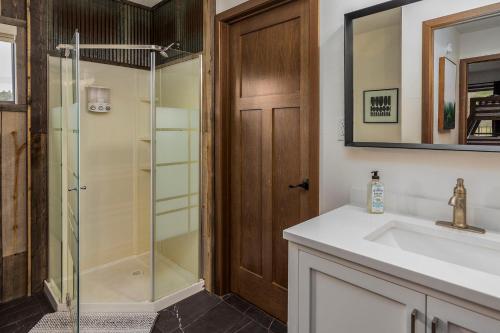 a bathroom with a shower and a sink at Cabin 6 at Horse Creek Resort in Rapid City