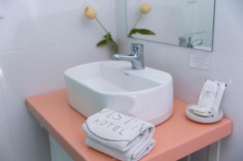 a bathroom with a sink and a towel on a counter at Hotel Vista La Floresta in La Floresta
