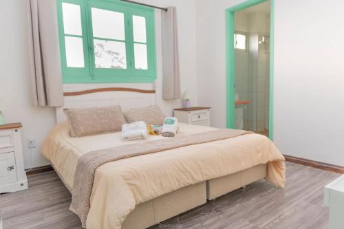 a bedroom with a large bed with two towels on it at Hotel Vista La Floresta in La Floresta