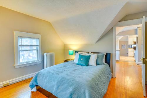 a bedroom with a bed with blue sheets and a window at Pet-Friendly Minneapolis Apartment Near Downtown! in Minneapolis