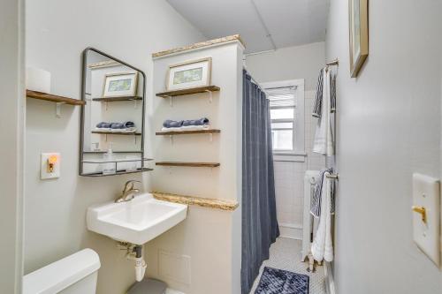 a small bathroom with a sink and a mirror at Cozy Minneapolis Apartment, 1 Mi to Downtown! in Minneapolis