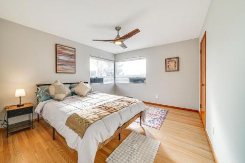 a bedroom with a bed and a ceiling fan at Quaint Renton Home about 15 Mi to Downtown Seattle! in Renton