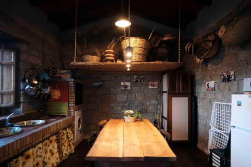 eine Küche mit einem Holztisch mit Körben an der Wand in der Unterkunft Atelier.Germana in CastellʼUmberto Vecchio