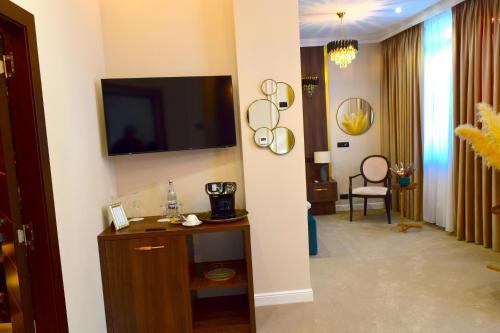 a living room with a television on a wall at Hotel 5 Continents in Craiova