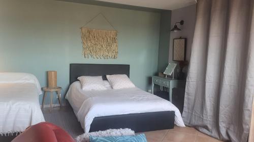 a bedroom with two beds and a table at Les Oliviers : Studio spacieux belle vue mer, Clim in Port-Vendres