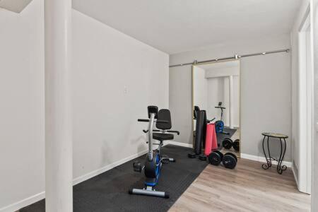 a room with a gym with exercise equipment in it at 3 Living Rooms - Spacious - Family-Friendly in National City