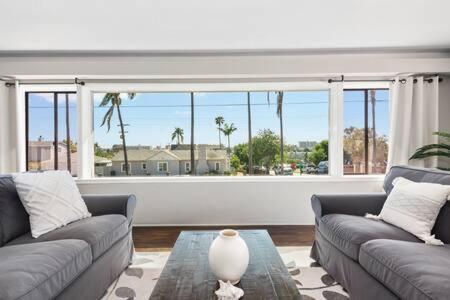 a living room with two couches and a large window at 3 Living Rooms - Spacious - Family-Friendly in National City