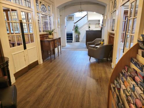 a hallway with chairs and a table in a building at The National Hotel in Dingwall