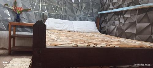 a bedroom with a bed with a wooden frame at Hermosa casa ubicada en la playa in Termales - agua caliente - nuqui