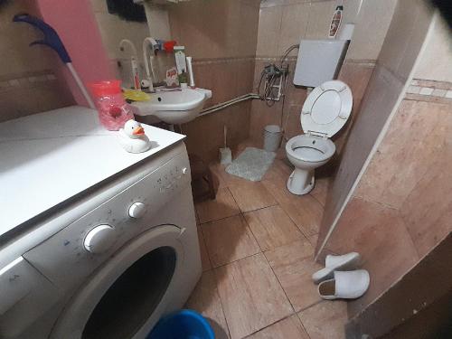 a bathroom with a washing machine and a toilet at Stay with Adem in Skopje
