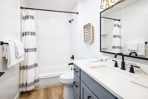 a bathroom with a sink and a toilet and a mirror at Near Downtown Stylish 2BR With Amazing Patio - 5 in Moab