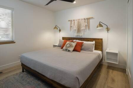 a bedroom with a bed with pillows and two lamps at Near Downtown Stylish 2BR With Amazing Patio - 6 in Moab
