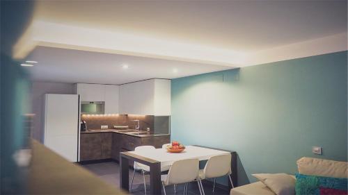 a living room with a table and a kitchen at Apartamento rural Castillo de Yeste 2 pax in Yeste