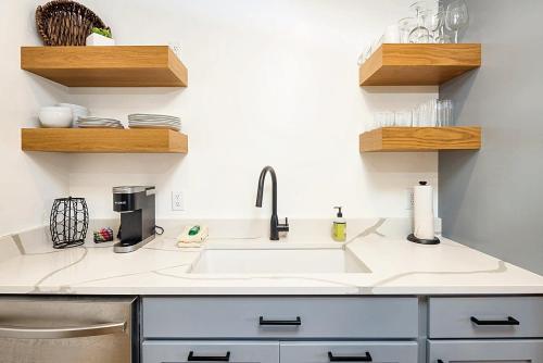 a kitchen with a sink and wooden shelves at Near Downtown Stylish 2BR With Amazing Patio - 4 in Moab