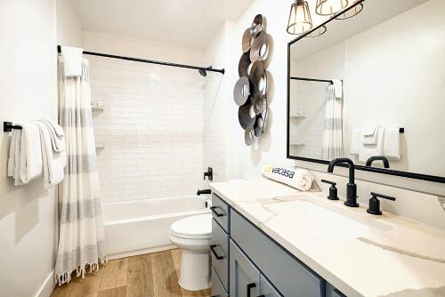 a bathroom with a sink and a toilet and a mirror at Near Downtown Stylish 2BR With Amazing Patio - 3 in Moab