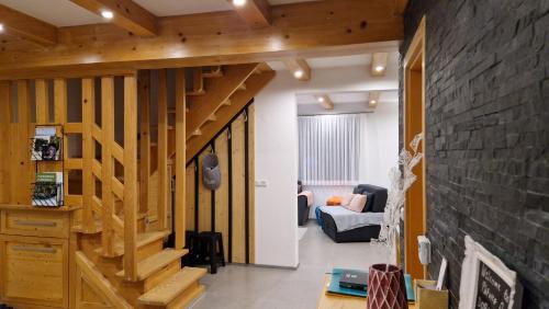 a room with a staircase and a living room at Plitvice Apis in Korenica