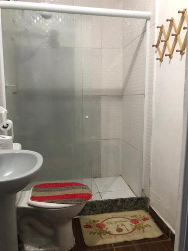 a bathroom with a shower with a toilet and a sink at Apartamento aconchegante com deck in Rio de Janeiro