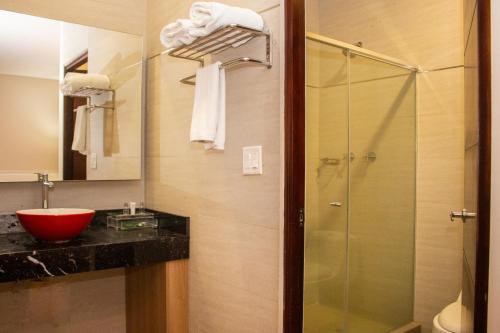 a bathroom with a glass shower and a sink at Ramada by Wyndham Panama Via Argentina in Panama City