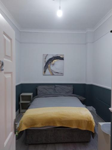 a bedroom with a bed with a yellow blanket at The corner house Longford town in Longford