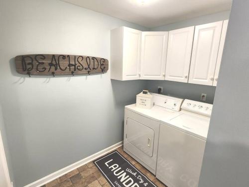 a small laundry room with a washer and dryer at Bobby's Beach Bungalow in Milford