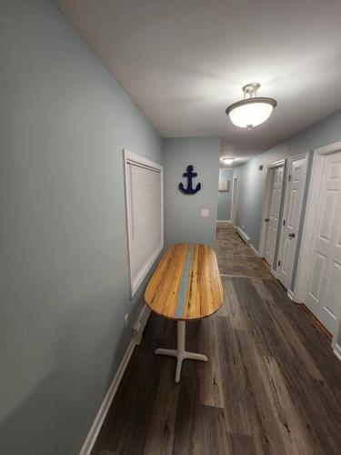 a hallway with a wooden table in a room at Bobby's Beach Bungalow in Milford