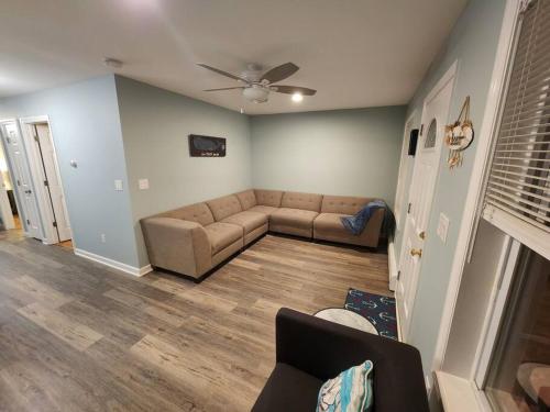 a living room with a couch and a ceiling fan at Bobby's Beach Bungalow in Milford