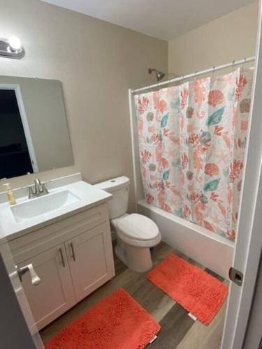 a bathroom with a sink toilet and a shower curtain at condo in downtown free parking 4 mins frm Freemont in Las Vegas