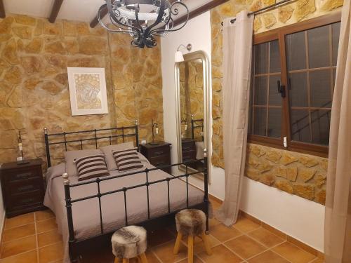 a bedroom with a bed with a mirror and a chandelier at Casa victoria in Soo