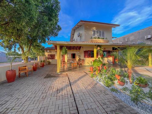 a house with a patio in front of it at Pousada de Bonito in Bonito
