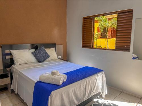 a bedroom with a bed with a towel on it at Pousada de Bonito in Bonito