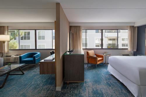 a hotel room with a bed and a desk at Hotel Dena, Pasadena Los Angeles, a Tribute Portfolio Hotel in Pasadena