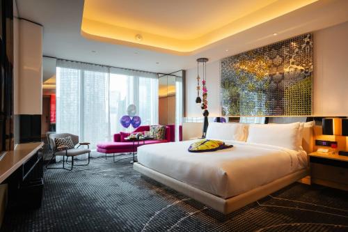 a hotel room with a bed and a living room at W Kuala Lumpur Hotel in Kuala Lumpur