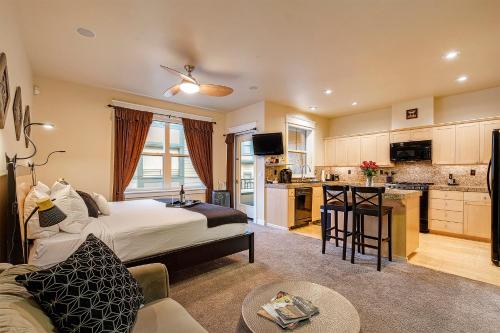 a hotel room with a bed and a kitchen with at The Orenco in Hillsboro