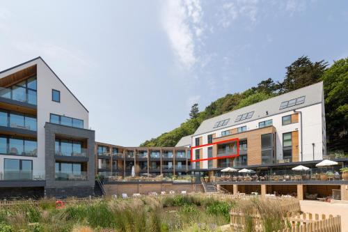 a rendering of a building with a hill in the background at Four The Reach in Salcombe