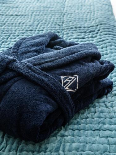 a blue towel laying on top of a bed at Four The Reach in Salcombe