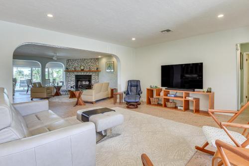 a living room with a couch and a fireplace at Waterfront Palmetto Home with Private Pool and Dock! in Palmetto