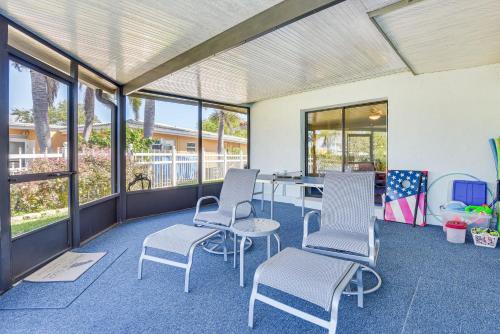 a room with chairs and a table and windows at Waterfront Palmetto Home with Private Pool and Dock! in Palmetto