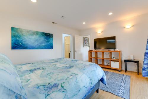 a bedroom with a bed and a flat screen tv at Greenbrae Garden Cottage Near Beaches and Redwoods in Green Brae
