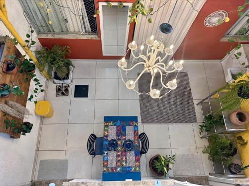 an overhead view of a living room with a chandelier at CASA LUMEN Home Hostel in Núcleo Bandeirante