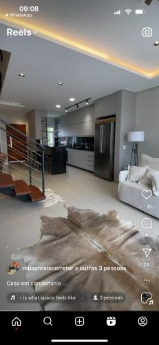 a view of a living room with a couch and a kitchen at Casa na zona sul de Porto Alegre in Porto Alegre