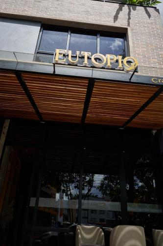 a bulipop sign on top of a building at Eutopiq Hotel in Medellín
