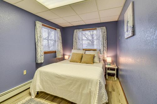 a bedroom with a bed and two windows at Montour Falls Apartment about 3 Mi to Seneca Lake! in Montour Falls