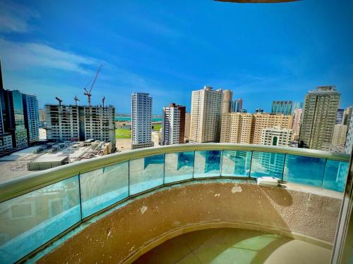 a walkway with a view of a city with tall buildings at Daniel TRYP in Sharjah
