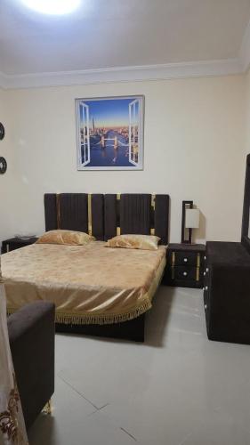 a bedroom with two beds and a picture on the wall at Daniel TRYP in Sharjah