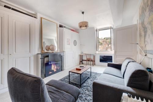 a living room with a couch and a fireplace at 50m² cosy près place Bellecour & vue s/ basilique in Lyon