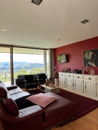 a living room with a couch and a table at Fontainha House & SPA in Caldelas