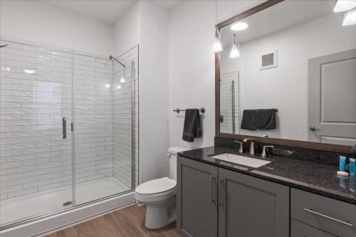 a bathroom with a shower and a toilet and a sink at Charming 1BR 1BA Apartment Near Downtown Cincinnati in Cincinnati